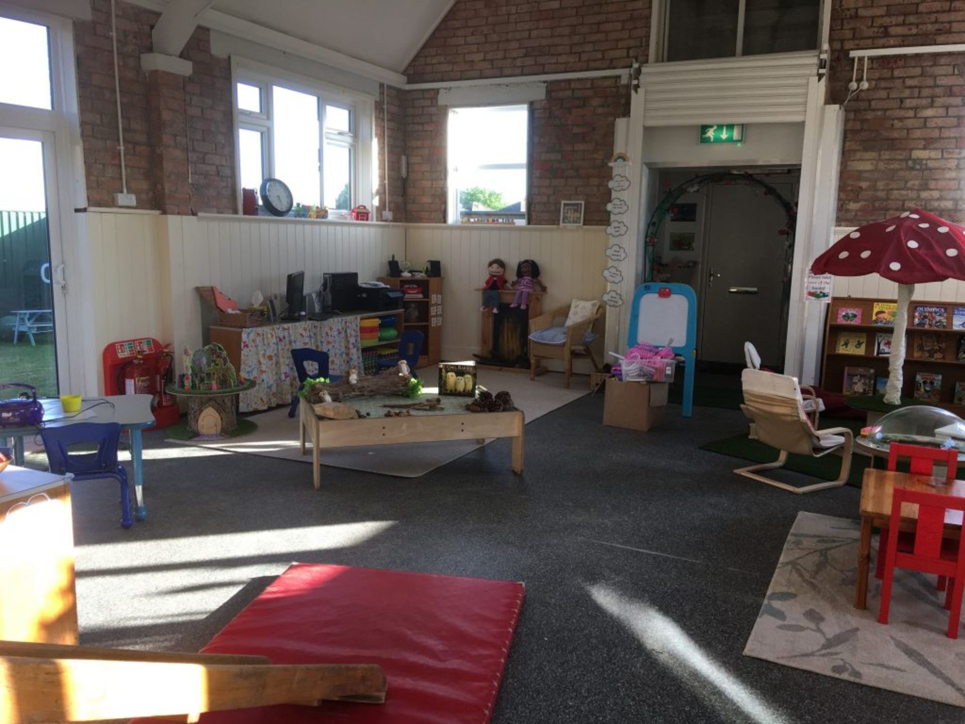 Bright preschool classroom with learning stations and natural light