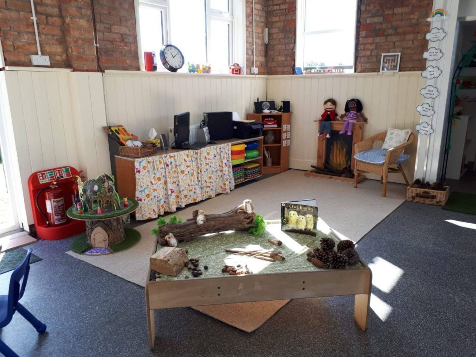 Organised early-years classroom with sand table and play areas